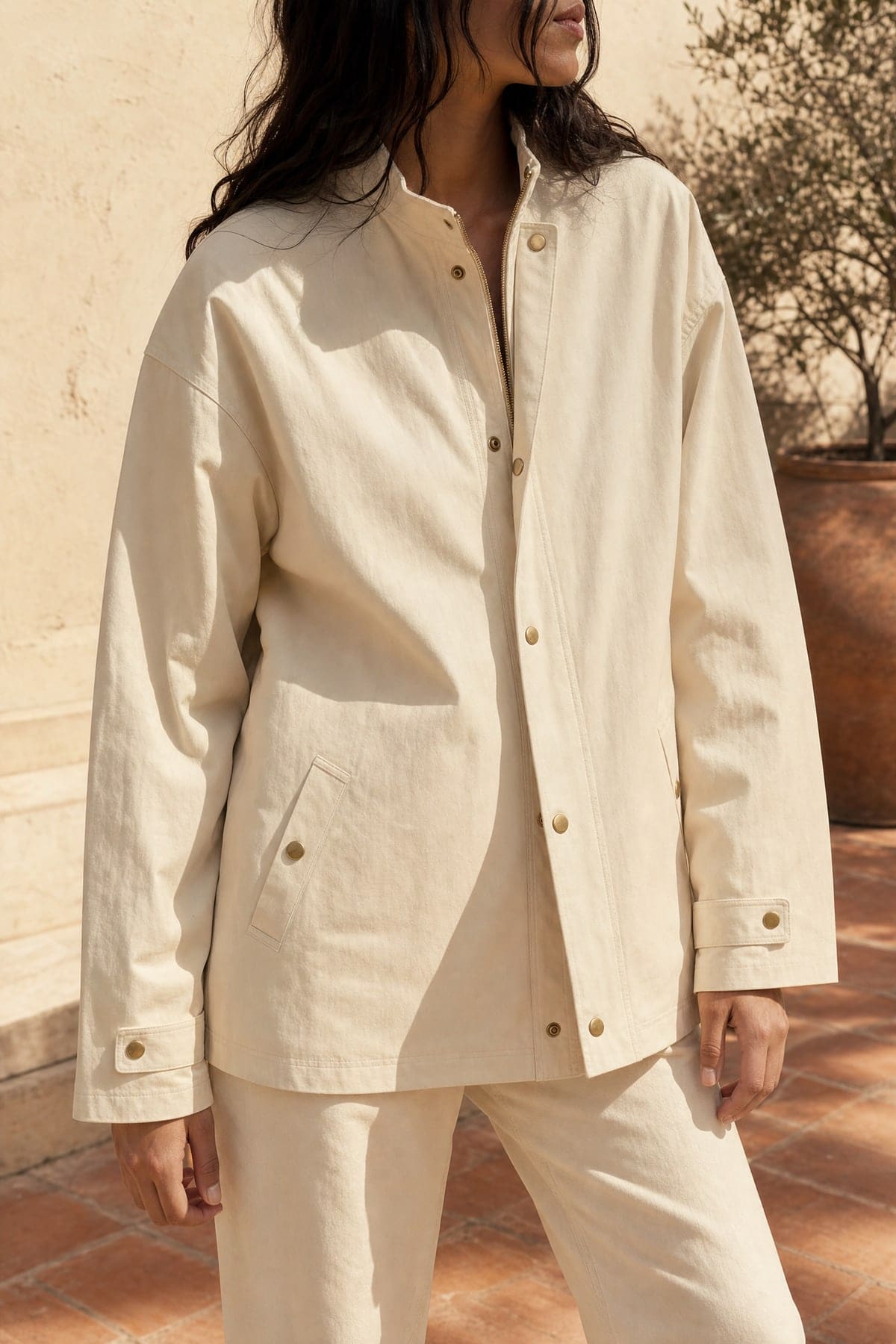Coach jacket in ecru, worn outdoors in warm afternoon light