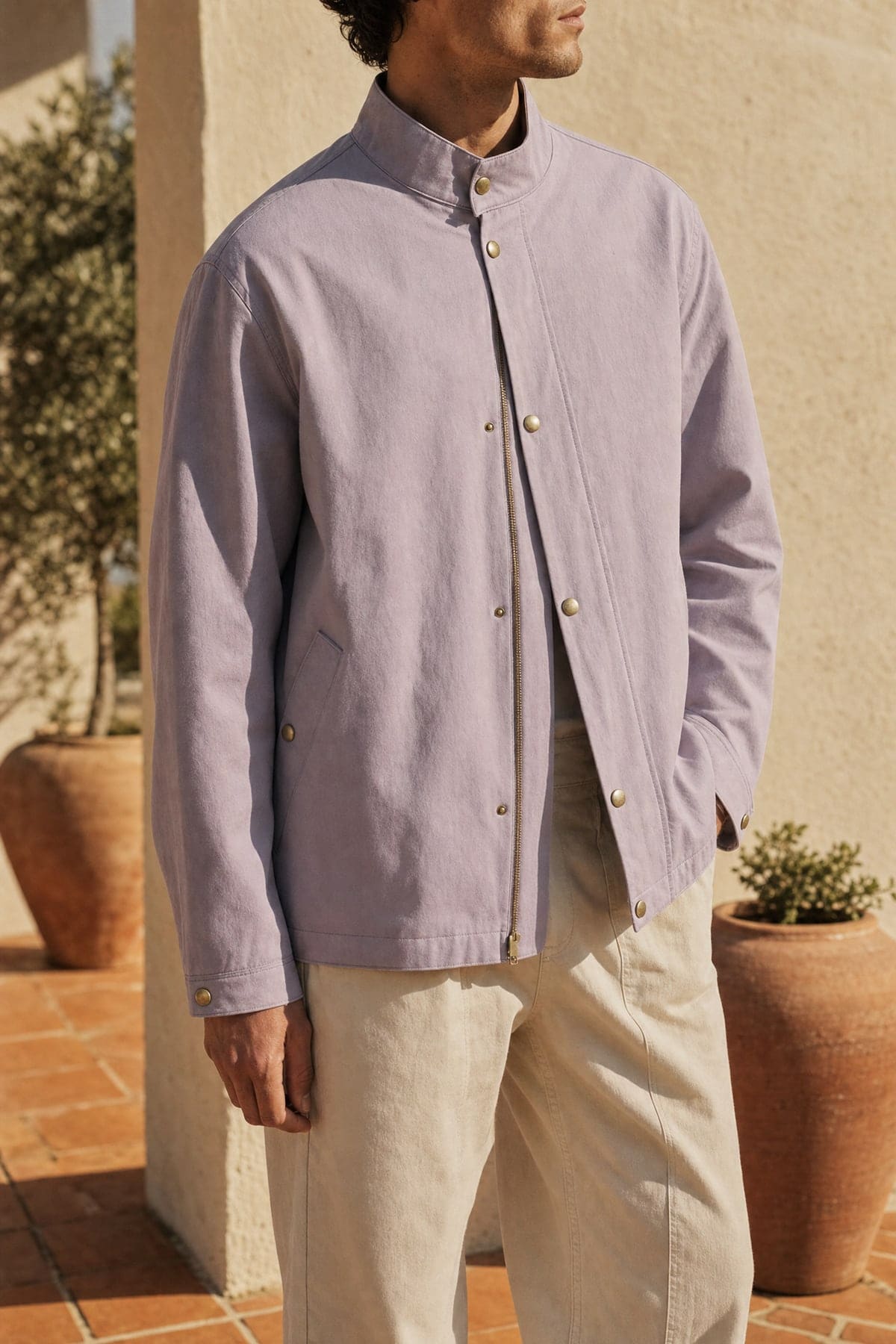 Coach jacket in lilac, worn outdoors in warm afternoon light