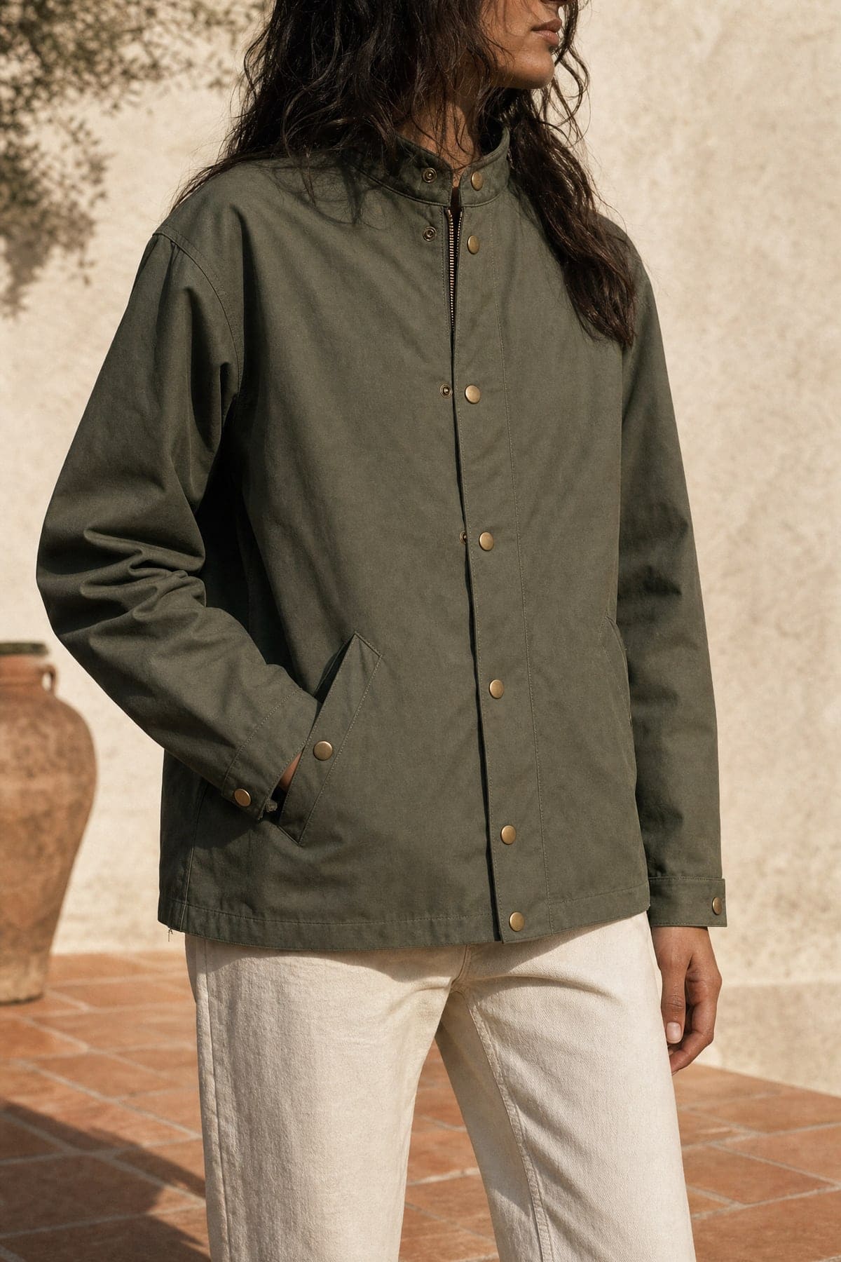 Coach jacket in olive, worn outdoors in warm afternoon light