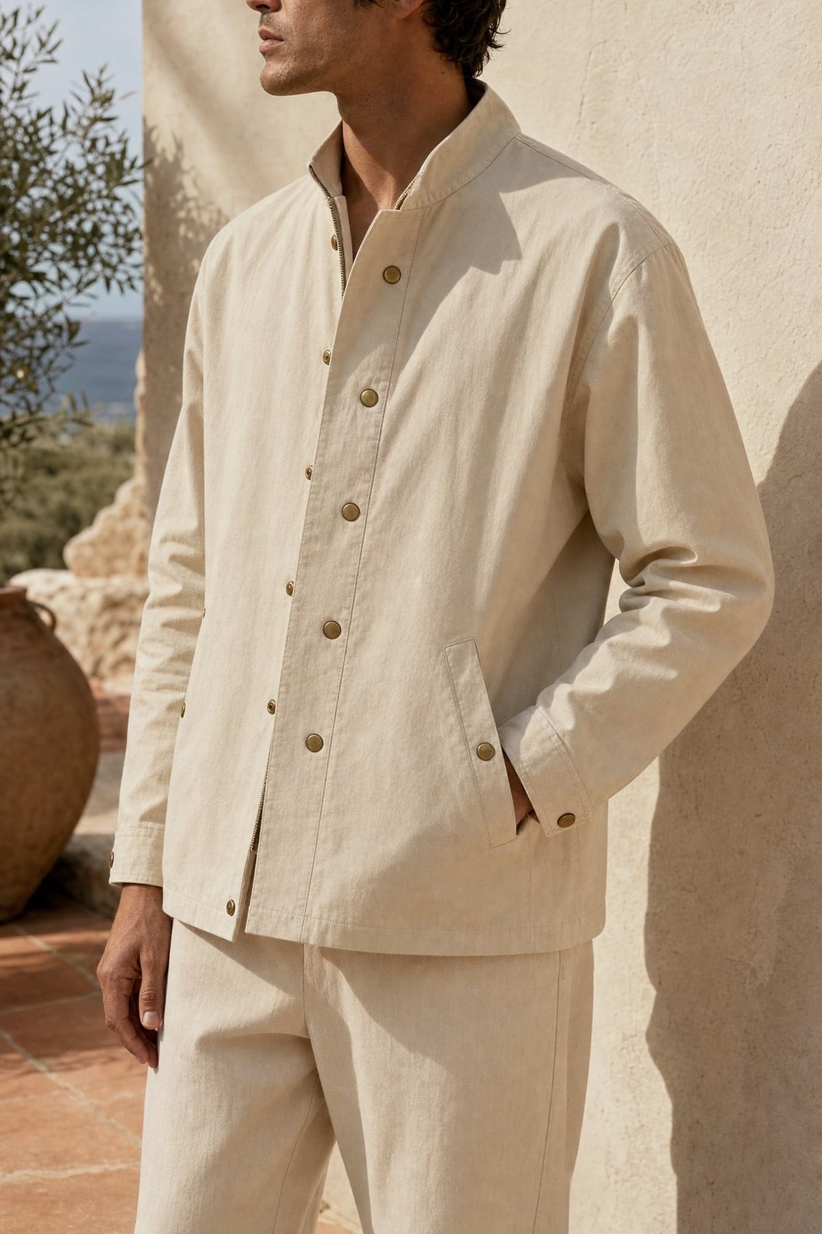 Coach jacket in sand, worn outdoors in warm afternoon light