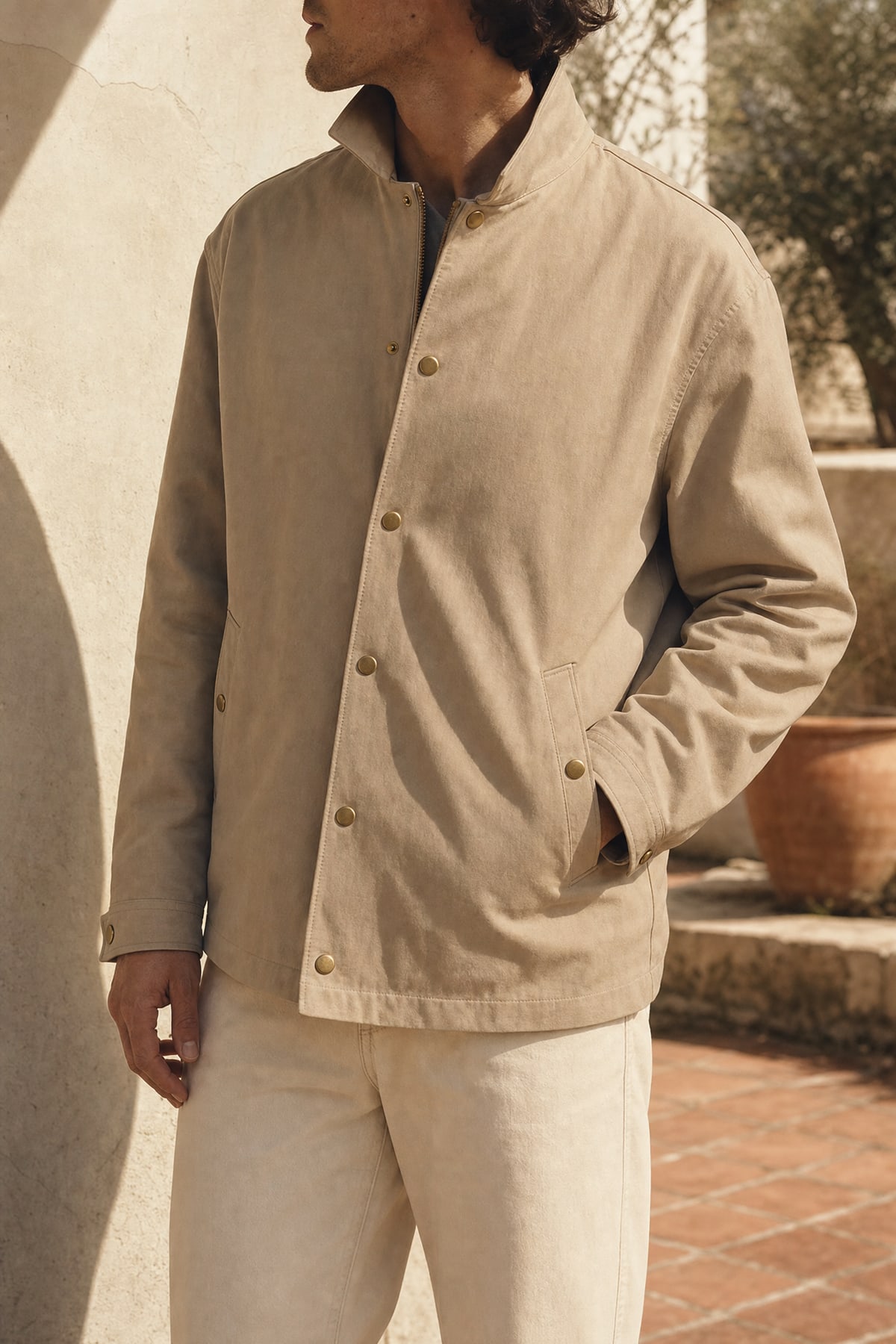 Coach jacket in stone, worn outdoors in warm afternoon light