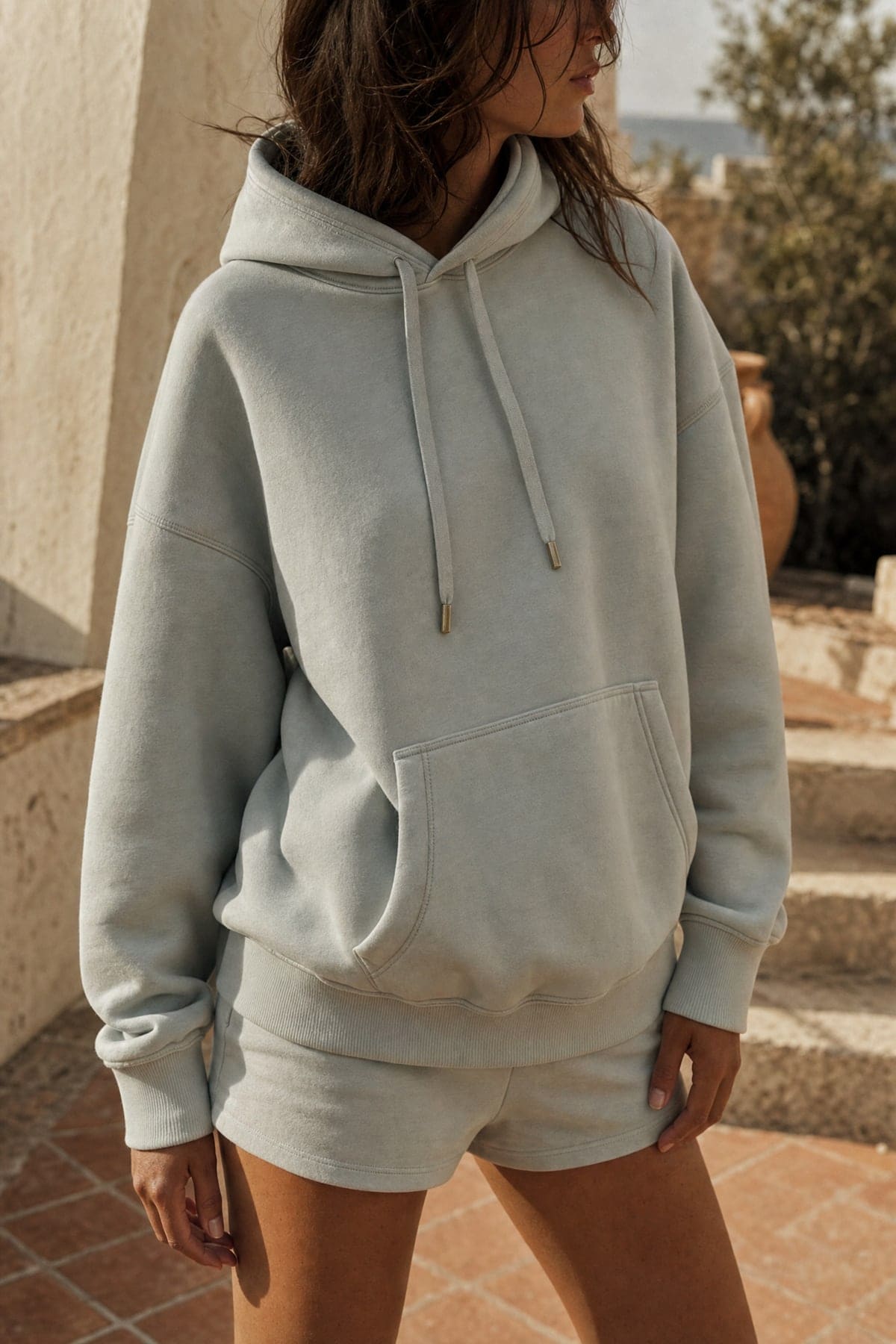 Hoodie in mist, worn outdoors in warm afternoon light