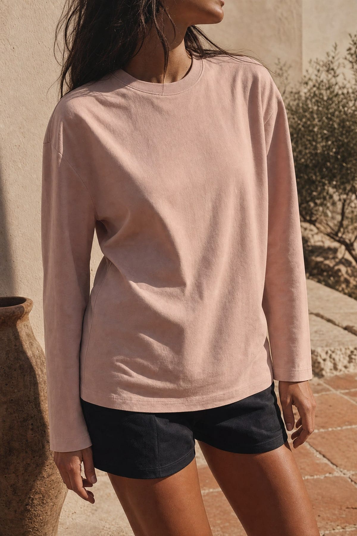 Long-sleeve in blush, worn outdoors in warm afternoon light