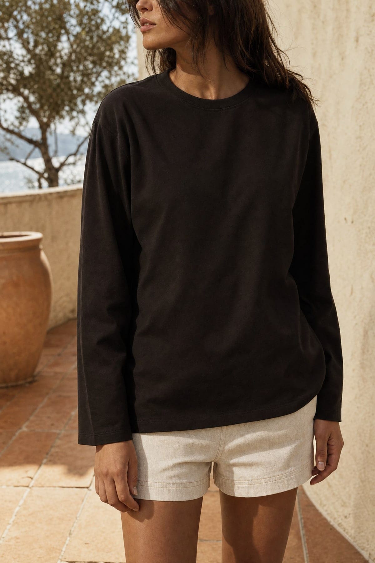 Long-sleeve in ink, worn outdoors in warm afternoon light