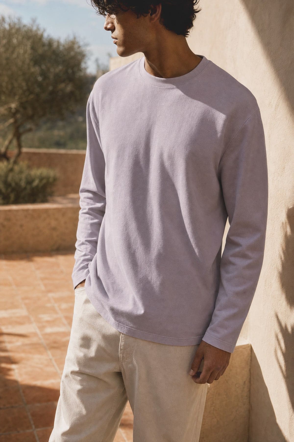Long-sleeve in lilac, worn outdoors in warm afternoon light