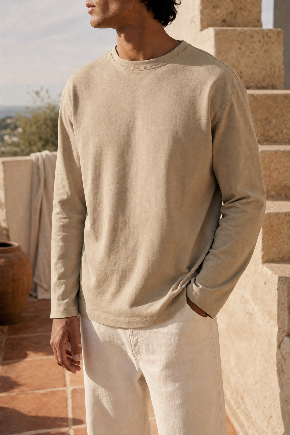 Long-sleeve in stone, worn outdoors in warm afternoon light
