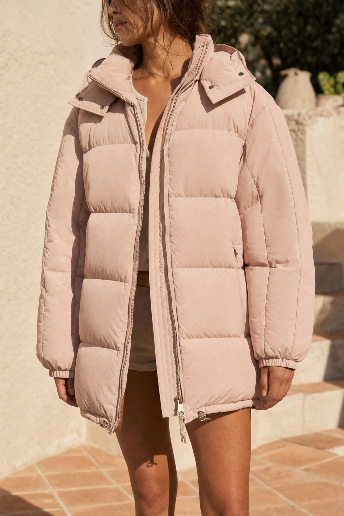 Puffer in blush, worn outdoors in warm afternoon light