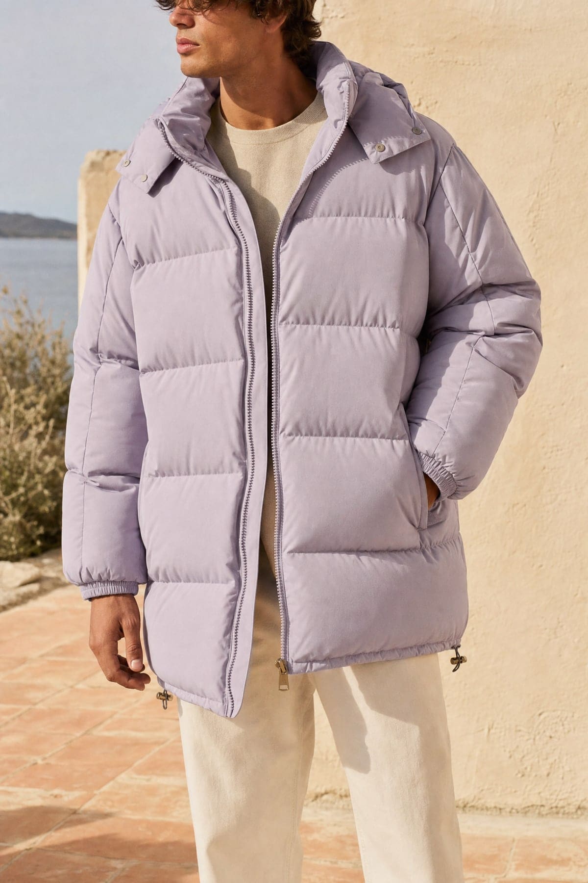 Puffer in lilac, worn outdoors in warm afternoon light
