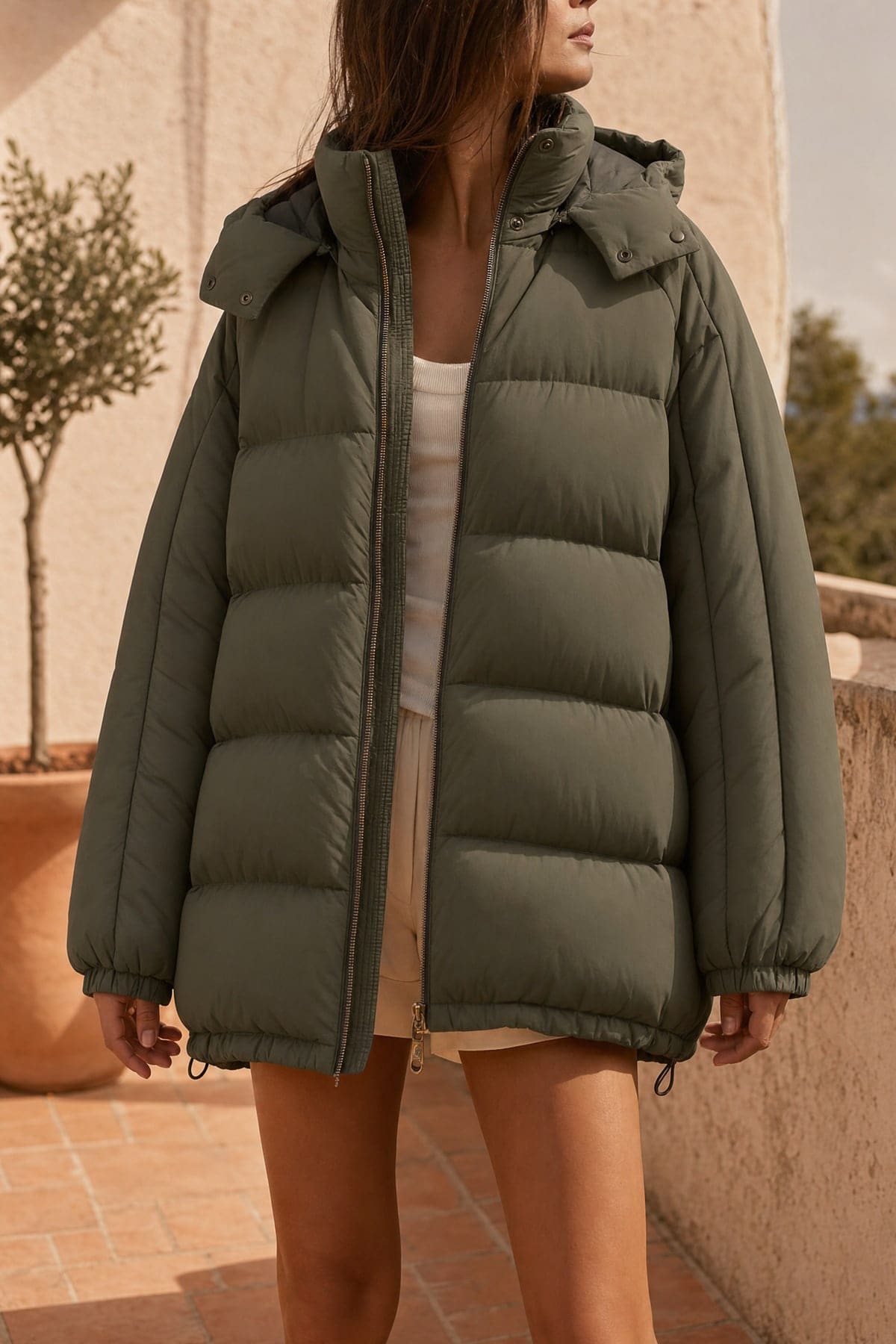 Puffer in olive, worn outdoors in warm afternoon light