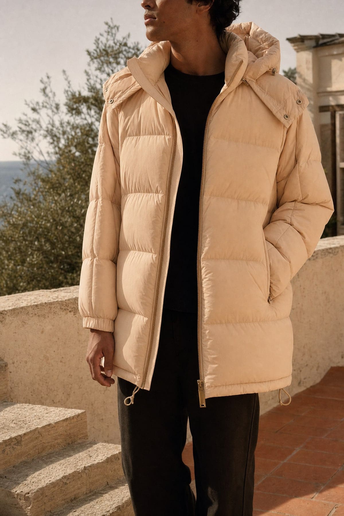 Puffer in peach, worn outdoors in warm afternoon light