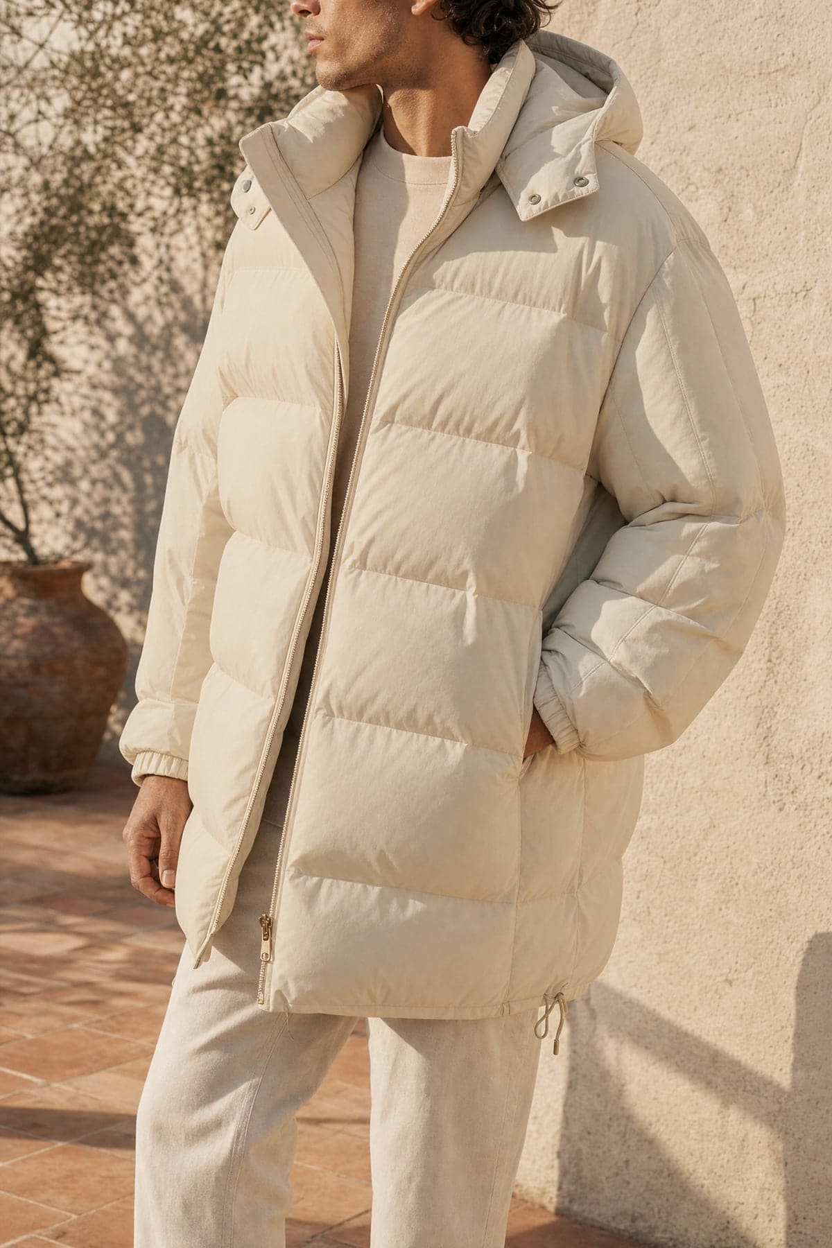Puffer in sand, worn outdoors in warm afternoon light