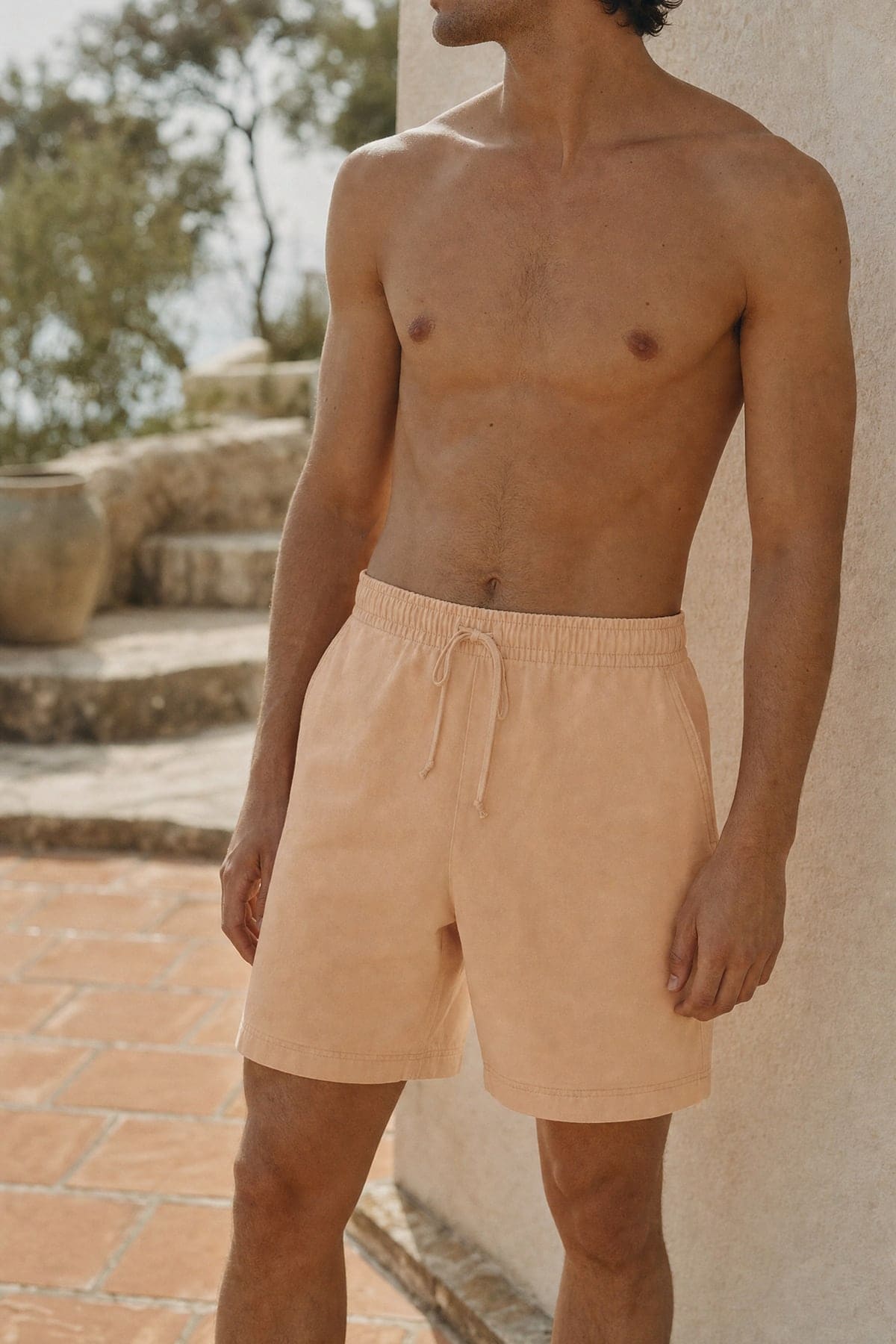 Shorts in peach, worn outdoors in warm afternoon light