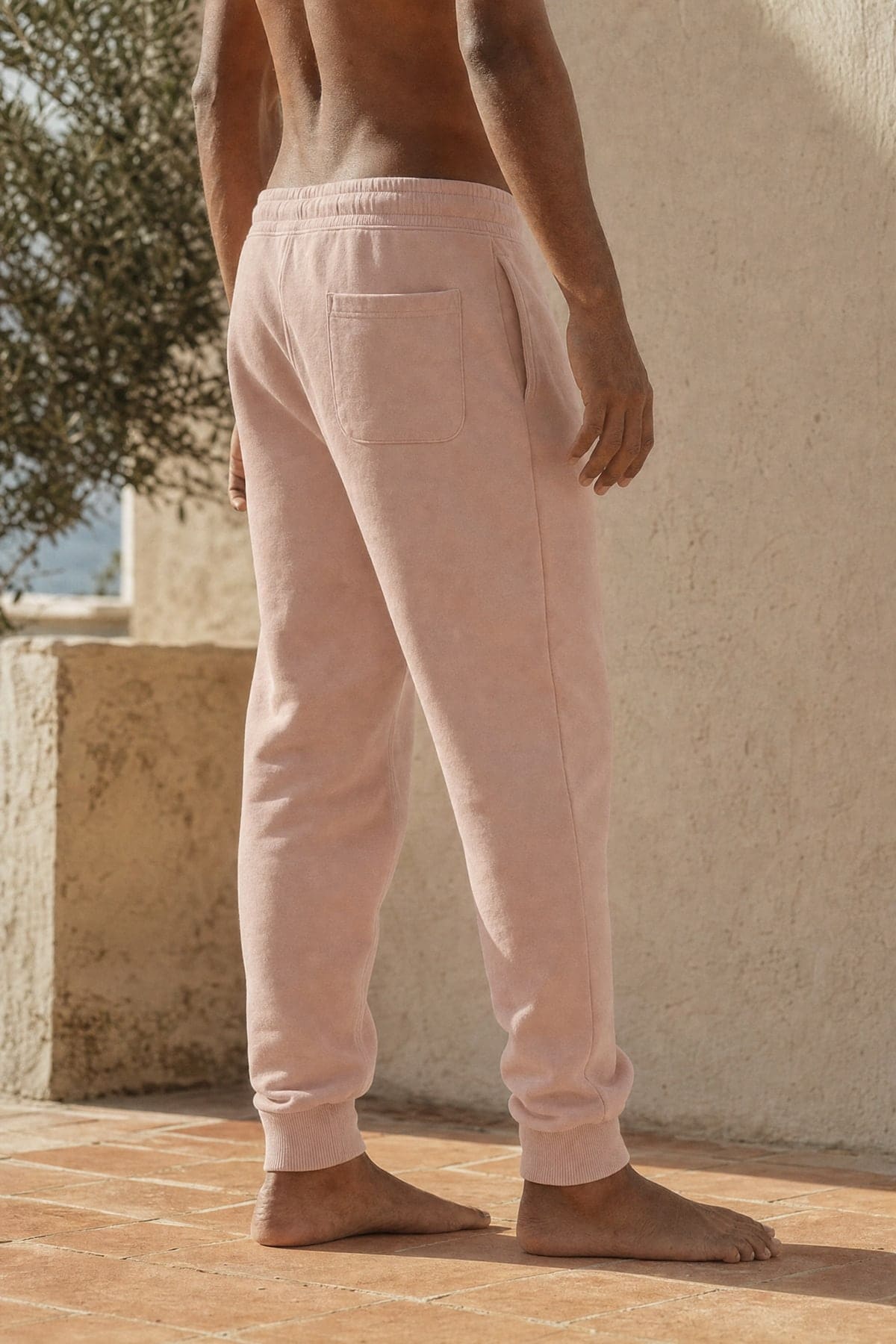 Sweats in blush, worn outdoors in warm afternoon light