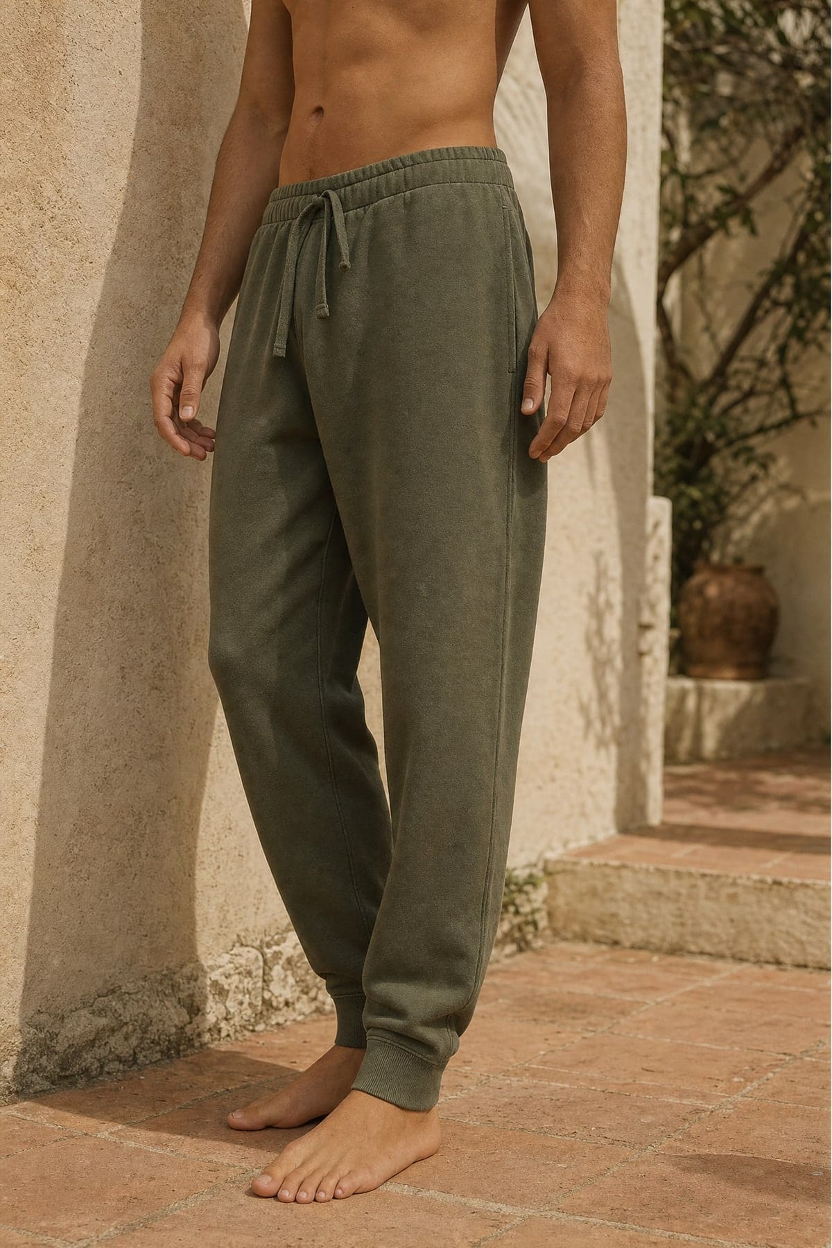 Sweats in olive, worn outdoors in warm afternoon light