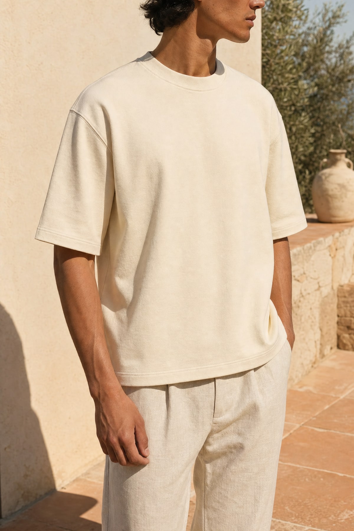 Tee in ecru, worn outdoors in warm afternoon light