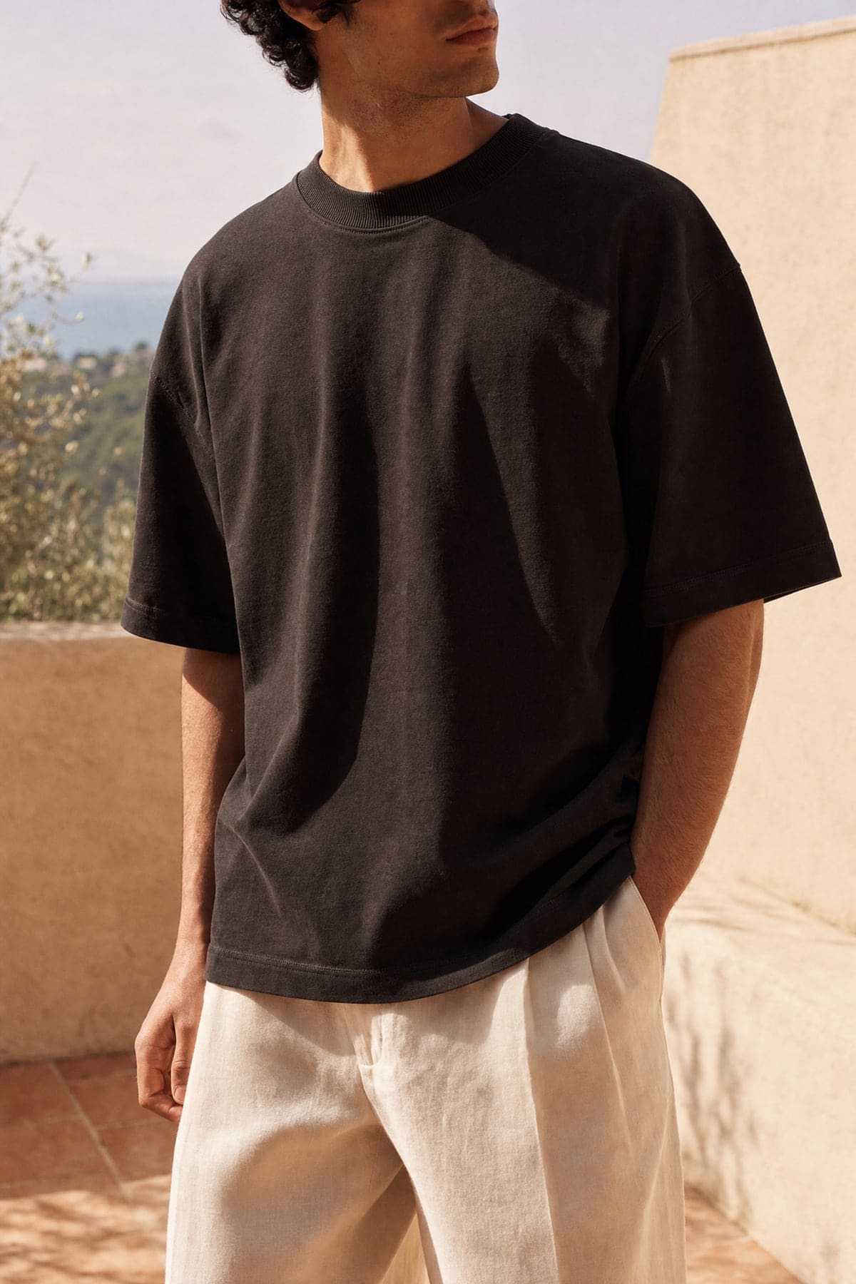 Tee in ink, worn outdoors in warm afternoon light