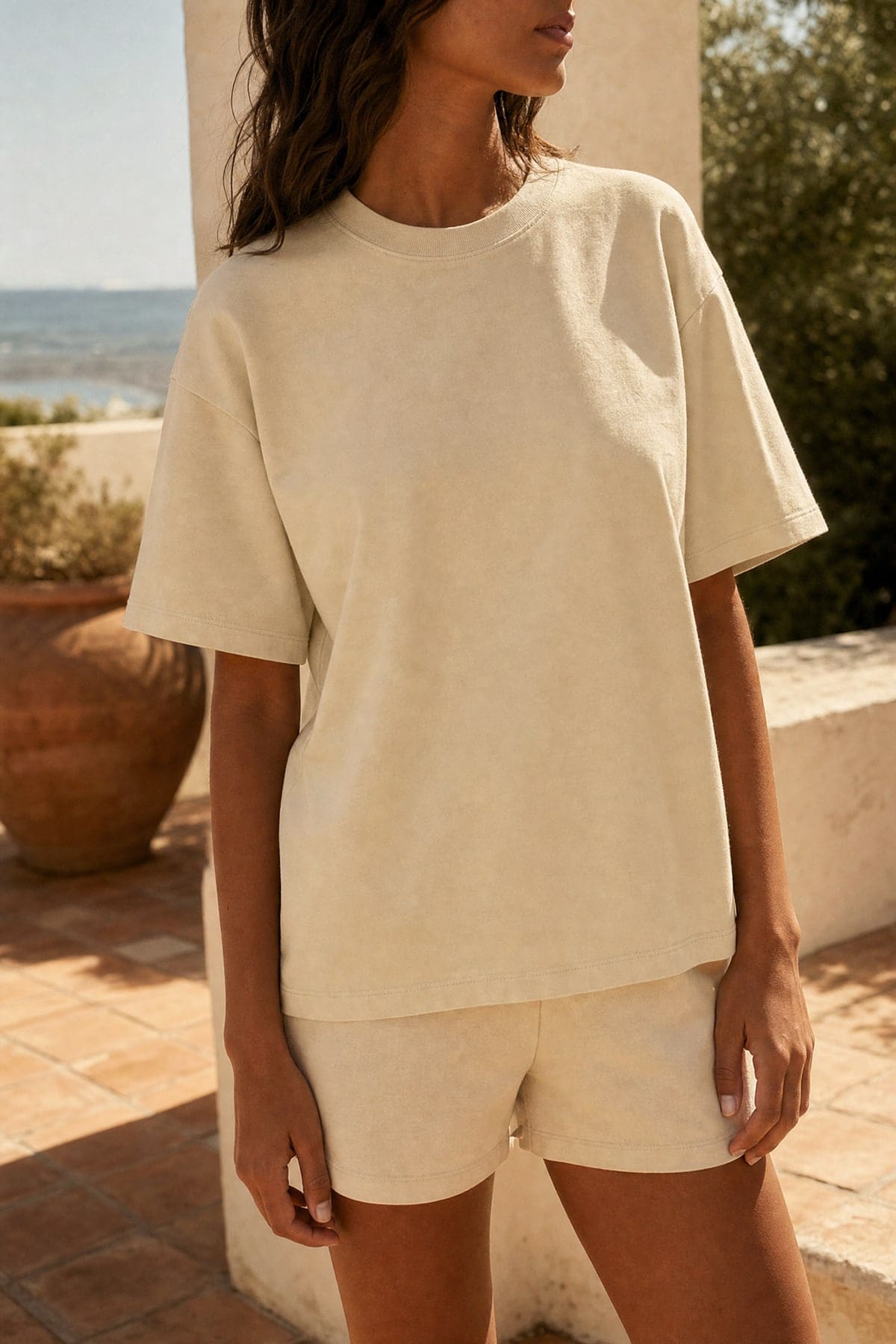 Tee in sand, worn outdoors in warm afternoon light
