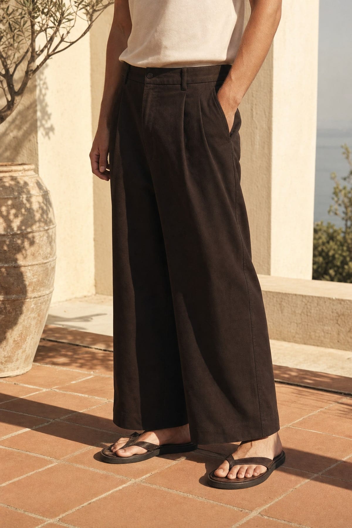 Wide pants in ink, worn outdoors in warm afternoon light