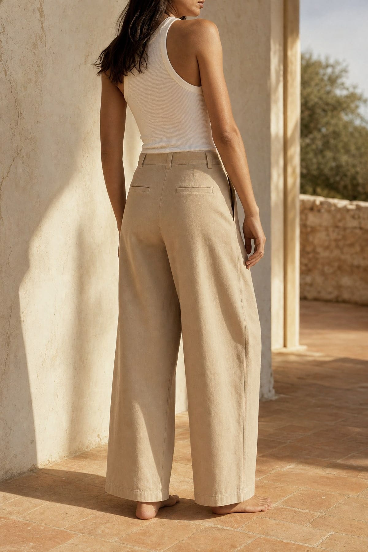 Wide pants in stone, worn outdoors in warm afternoon light